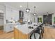 Modern kitchen with white cabinets, marble countertops and a large island at 322 Waldo St, Cary, NC 27511