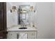 Elegant powder room with a unique mirror and marble vanity at 12660 Boyce Milll Road, Raleigh, NC 27613