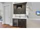 Wet bar with a beverage refrigerator and marble countertop at 12660 Boyce Milll Road, Raleigh, NC 27613