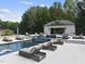 Relaxing pool area with multiple lounge chairs and cabana at 12660 Boyce Milll Road, Raleigh, NC 27613