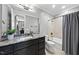 Modern bathroom with dark vanity, shower, and bathtub at 12660 Boyce Milll Road, Raleigh, NC 27613