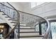 Elegant curved staircase with ornate railing and hardwood at 12660 Boyce Milll Road, Raleigh, NC 27613
