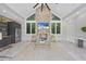 Sunroom with stone fireplace, large windows, and built-in kitchen area at 12660 Boyce Milll Road, Raleigh, NC 27613