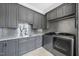 Laundry room with gray cabinets and stainless steel appliances at 12660 Boyce Milll Road, Raleigh, NC 27613