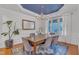 Formal dining room with dark wood table, grey chairs, and blue accent wall at 7719 Berry Crest Ave, Raleigh, NC 27617