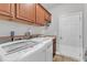 Laundry room with washer, dryer, cabinets, and utility sink at 7719 Berry Crest Ave, Raleigh, NC 27617