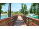 Wooden dock extending over a serene lake with fountain at 201 Big Bradley Dr, Wendell, NC 27591