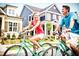Couple enjoying a bike ride in a charming community at 201 Big Bradley Dr, Wendell, NC 27591