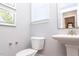 Stylish powder room with pedestal sink and white toilet at 173 Ascot, Rocky Mount, NC 27804