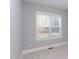 Bright bedroom with neutral walls, carpet, and a large window at 173 Ascot, Rocky Mount, NC 27804