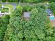 Aerial view of house nestled in a wooded area at 6117 Hilbert Ridge Dr, Holly Springs, NC 27540