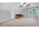 Spacious bedroom with a futon and large window at 6117 Hilbert Ridge Dr, Holly Springs, NC 27540