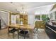 Elegant dining room features a wood table, chandelier, and access to staircase at 613 S Fuquay Ave, Fuquay Varina, NC 27526