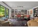 Living room with dark hardwood floors, built-in shelving and access to backyard at 1201 Bancroft St, Raleigh, NC 27612