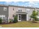 Townhouse rear view with screened porch and landscaping at 125 Hunston Dr, Holly Springs, NC 27540