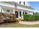 Front porch detail with American flag, brick planter, and landscaping at 72 Cokesbury Park Ln, Fuquay Varina, NC 27526