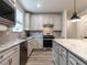 Modern kitchen features granite countertops and stainless steel appliances at 1308 Holly Blue, Fuquay Varina, NC 27526