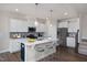 Modern kitchen with white cabinets, quartz countertops, and stainless steel appliances at 821 Rolling Wheel Rd, Mebane, NC 27302