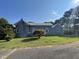 Side view of a house with a metal roof and landscaping at 409 W Main St, Spring Hope, NC 27882