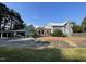 Rear view of the house showcasing parking area and landscape at 409 W Main St, Spring Hope, NC 27882