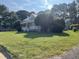 Gray house with a large front yard and mature trees at 409 W Main St, Spring Hope, NC 27882