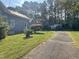 House exterior showing side yard, driveway and detached garage at 409 W Main St, Spring Hope, NC 27882