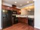 Kitchen with dark wood cabinets and black appliances at 202 Linden Park Ln, Cary, NC 27519