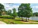 Scenic lakefront view with a gazebo and walking path at 202 Linden Park Ln, Cary, NC 27519