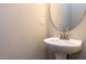 Small bathroom with pedestal sink and oval mirror at 202 Linden Park Ln, Cary, NC 27519