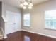 Bright dining area with hardwood floors and white doors at 202 Linden Park Ln, Cary, NC 27519