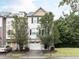 Two-story townhome with two-car garage and manicured lawn at 202 Linden Park Ln, Cary, NC 27519