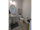 Powder room with pedestal sink, toilet, and grey tile floor at 1491 Pecan Dr # Model Home, Nashville, NC 27856