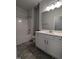 Clean bathroom with white vanity, tub, and grey tile flooring at 1491 Pecan Dr # Model Home, Nashville, NC 27856