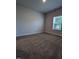 Spacious carpeted bedroom with large window and neutral walls at 1491 Pecan Dr # Model Home, Nashville, NC 27856