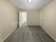 Simple bedroom with grey carpet and access to the hallway at 1517 Wiljohn Rd, Garner, NC 27529