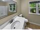 Clean bathroom with updated white vanity and large windows at 1517 Wiljohn Rd, Garner, NC 27529