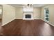 Living room with dark wood flooring and a fireplace at 1517 Wiljohn Rd, Garner, NC 27529