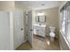 Updated bathroom with white vanity, toilet and a shower at 1517 Wiljohn Rd, Garner, NC 27529