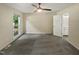Spacious bedroom with grey carpet and a large window at 1517 Wiljohn Rd, Garner, NC 27529