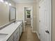 Main bathroom with updated vanity and flooring at 1517 Wiljohn Rd, Garner, NC 27529
