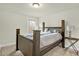 Comfortable bedroom featuring a dark wood bed frame and side table at 1042 Longleaf Pine Pl, Mebane, NC 27302