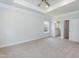 Main bedroom with tray ceiling, carpeting, attached bathroom, and window at 67 Decatur Dr, Fuquay Varina, NC 27526