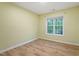 Simple bedroom with window and light wood flooring at 4312 Windstorm Way, Raleigh, NC 27616