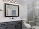 Stylish bathroom with gray vanity, white subway tile shower, and a toilet at 142 Lila Dr, Pittsboro, NC 27312
