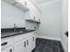 Laundry room with white cabinets and dark granite countertops at 142 Lila Dr, Pittsboro, NC 27312