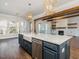 Modern kitchen island with white quartz countertops and blue cabinetry at 142 Lila Dr, Pittsboro, NC 27312