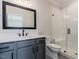 Modern bathroom with gray vanity, white tile shower, and frameless glass at 142 Lila Dr, Pittsboro, NC 27312