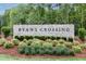 Community entrance sign for Ryan's Crossing, showcasing landscaping and stonework at 142 Lila Dr, Pittsboro, NC 27312