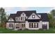 Two-story home with white brick, dark trim, and a metal roof at 142 Lila Dr, Pittsboro, NC 27312