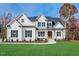 Two story home with white brick and a welcoming front porch at 142 Lila Dr, Pittsboro, NC 27312